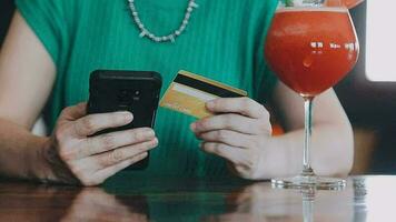 Hands holding credit card and using laptop. Online shopping video