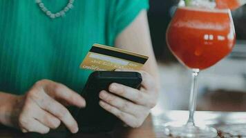 Hands holding credit card and using laptop. Online shopping video