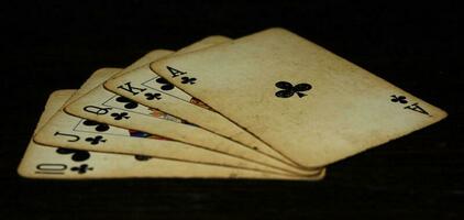 Royal flush of clubs on a black background photo