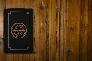 Occult book on a wooden desk photo