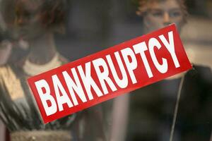 Bankruptcy banner in a window shop photo