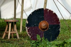 Viking shield leaning against a tent peg photo