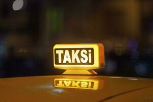 Illuminated yellow Turkish taxi sign photo