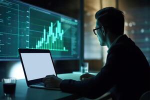 Side View of Handsome Businessman Using Laptop and Sitting at Desk with Green Financial Dashboard In Dark Room. Generative AI Illustration. photo