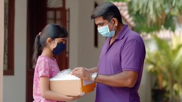 Side View of Middle Aged Indian Man and Girl Opening Parcel in Protective Mask at Door, . photo