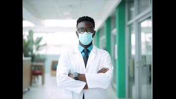 Mid Aged African Male Doctor Wearing Face Mask While Standing in the Hospital Corridor, . photo
