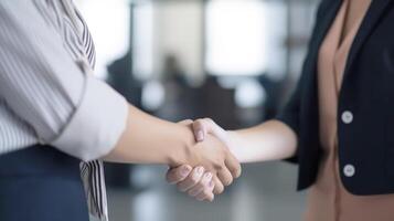 Business handshake between two women. Close up. Inside a modern bright office. . photo