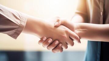 Friendly or casual handshake between two women. Close up. . photo