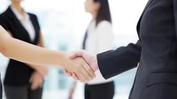 Business handshake between two women. Close up. Inside a modern bright office. . photo