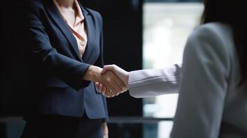 Business handshake between two women. Close up. Inside a modern bright office. . photo