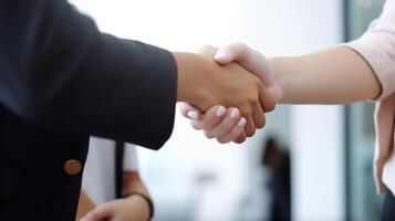 Business handshake between two women. Close up. Inside a modern bright office. . photo