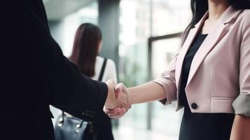 Business handshake between two women. Close up. Inside a modern bright office. . photo