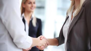 Business handshake between two women. Close up. Inside a modern bright office. . photo