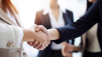 Business handshake between two women. Close up. Inside a modern bright office. . photo