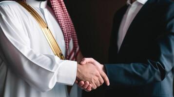 Business handshake between two Arabian Man. Close up on black Background. . photo