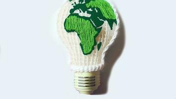 World map embroidered inside a light bulb. photo