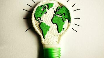 World map embroidered inside a light bulb. photo
