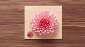 Top View of Beautiful Dahlia Flowers at Square Paper Card Mockup on Wooden Table, . photo