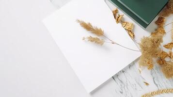 Top View of Blank White and Green Paper with Dry Pampas Flowers, Golden Leaves on Background and Placement. Summer or Wedding Card Design. . photo