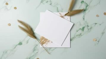 Top View of Blank White Papers with Pampas Grass on Green Marble Background. Vintage Delicate Wedding or Business Card Design. . photo