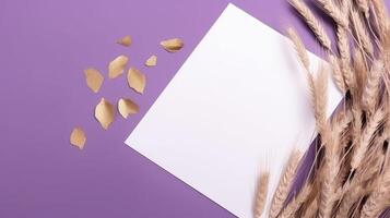 Top View of Blank White Paper with Dried Wheat on Purple Background and Placement. Vintage Delicate Business or Wedding Card Design. . photo