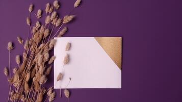 Top View of Blank White and Golden Paper with Dried Pampas Grass on Purple Background. Vintage Delicate Business or Wedding Card Design and Space for Your Message. . photo