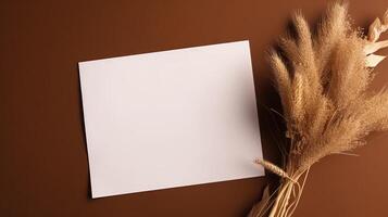 Top View of Blank White Paper with Dry Pampas Grass on Shiny Brown Background for Vintage Delicate Business or Wedding Card Design. Generative AI. photo