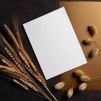 Top View of Blank White Paper with Golden Reeds Branch on Shiny Brown Background for Vintage Delicate Business or Wedding Card Design. . photo