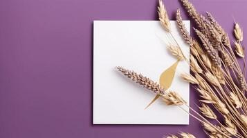 Top View of Blank White Paper with Dried Reed Branch on Purple Background. Vintage Delicate Business or Wedding Card Design and Space for Your Message. Generative AI. photo