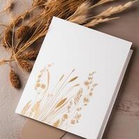 White Blank Invitation Card with Golden Floral Embossing Mockup, Pampas Grass. . photo