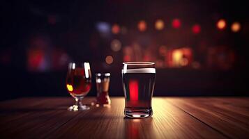 Liquor Glasses on Wooden Table. Blurred Interior of Pub at the Background. . photo