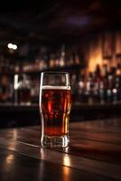 Cold Beer Glass on Wooden Table. Blurred Interior of Pub at the Background. . photo