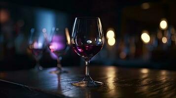 Cropped Shot of Wine Glasses on Wooden Table at Blur Lighting Background for Night Party. photo