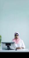 Cropped Image of Muslim Female Doctor Sitting at Workplace with Desktop, Vertical Banner Design. . photo