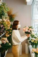 Side View Portrait of Female Florist Wearing Mask and Holding Roses Bouquet in Her Floral Shop, Generative AI. photo