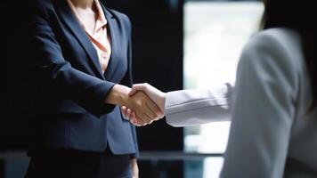 Cropped Image of Business handshake between two women Inside a modern bright office. . photo