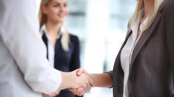 Cropped Image of Business handshake between two women Inside a modern bright office. . photo