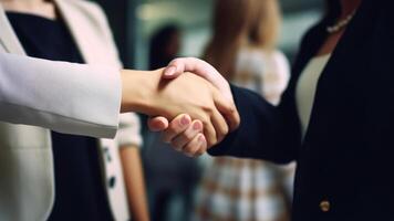 Cropped Image of Business handshake between two women Inside a modern bright office. . photo