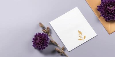 Top View of Invitation Card Mockup with Purple Dahlia Flowers, Dried Buds Twig on Pastel Blue Background, . photo