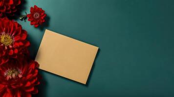 Top View of Blank Invitation Card Mockup and Beautiful Red Zinnia Flowers on Green Background. . photo