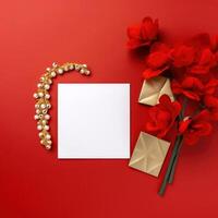 Top View of White and Golden Blank Card Mockup with Beautiful Blossom, Jewellery on Red Background. . photo