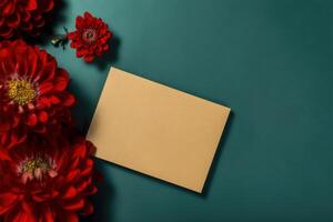 Top View of Blank Invitation Card Mockup and Beautiful Red Zinnia Flowers on Green Background. . photo