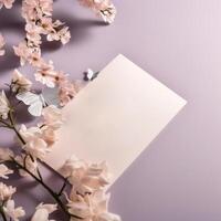 Top View of Blank Paper Card Mockup and Beautiful Flowers Branch Having Bright Light Color Incredibly Detailed Butterflies. . photo