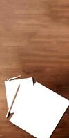 Top View of Blank White Paper Mockup, Large Pencil, Geometric Compass Key on Brown Plank Texture Background. . photo