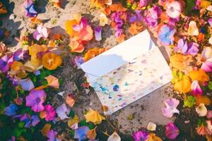 Top View of Greeting Card Mockup and Multicolored Flowers on Soil Background, . photo