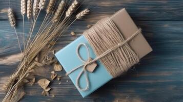 Top View of Rustic Style Packed Gift Box Tied with Burlap Thread and Dried Grain Grass on Vintage Wooden Table, . photo