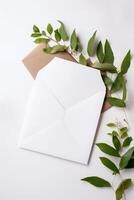 Top View of Blank Invitation Card, Envelope with Eucalyptus Leaves. Mockup Template for Design or Product Placement Created Using . photo