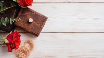 Top View of Diamond Ring on Wooden Box with Red Roses, Jute Thread Against White Plank Texture Table. . photo