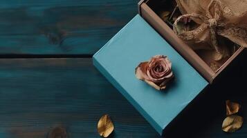 Closeup of Vintage Wooden Box with Dried Rose, Burlap Cloth on Old Plank Texture Table Top. . photo