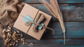 Top View of Rustic Style Packed Gift Box with Burlap Cloth and Dried Grain on Vintage Wooden Table, . photo